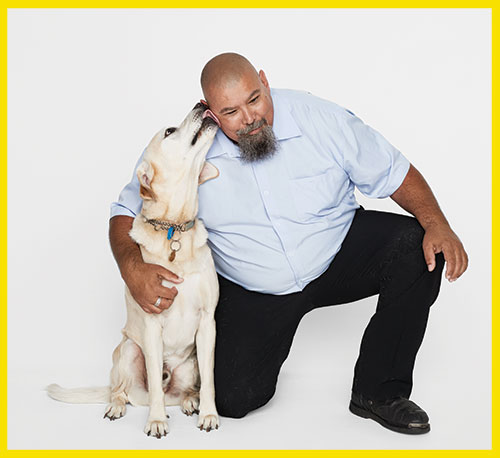 Seeing Eye Dog licking the side of his handler's face