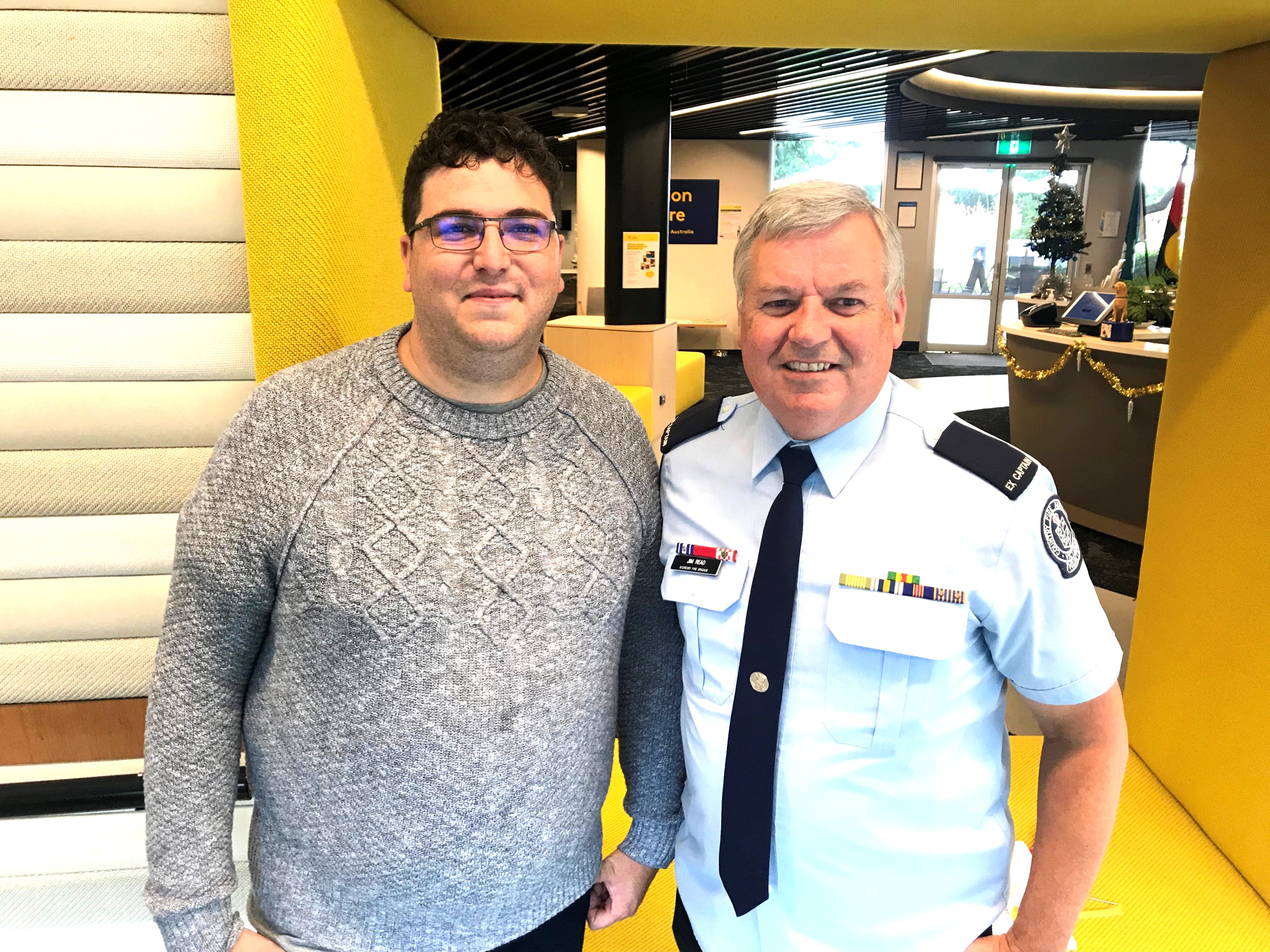CFA volunteer Jim Read dressed in uniform standing with Josh from the CFA podcast