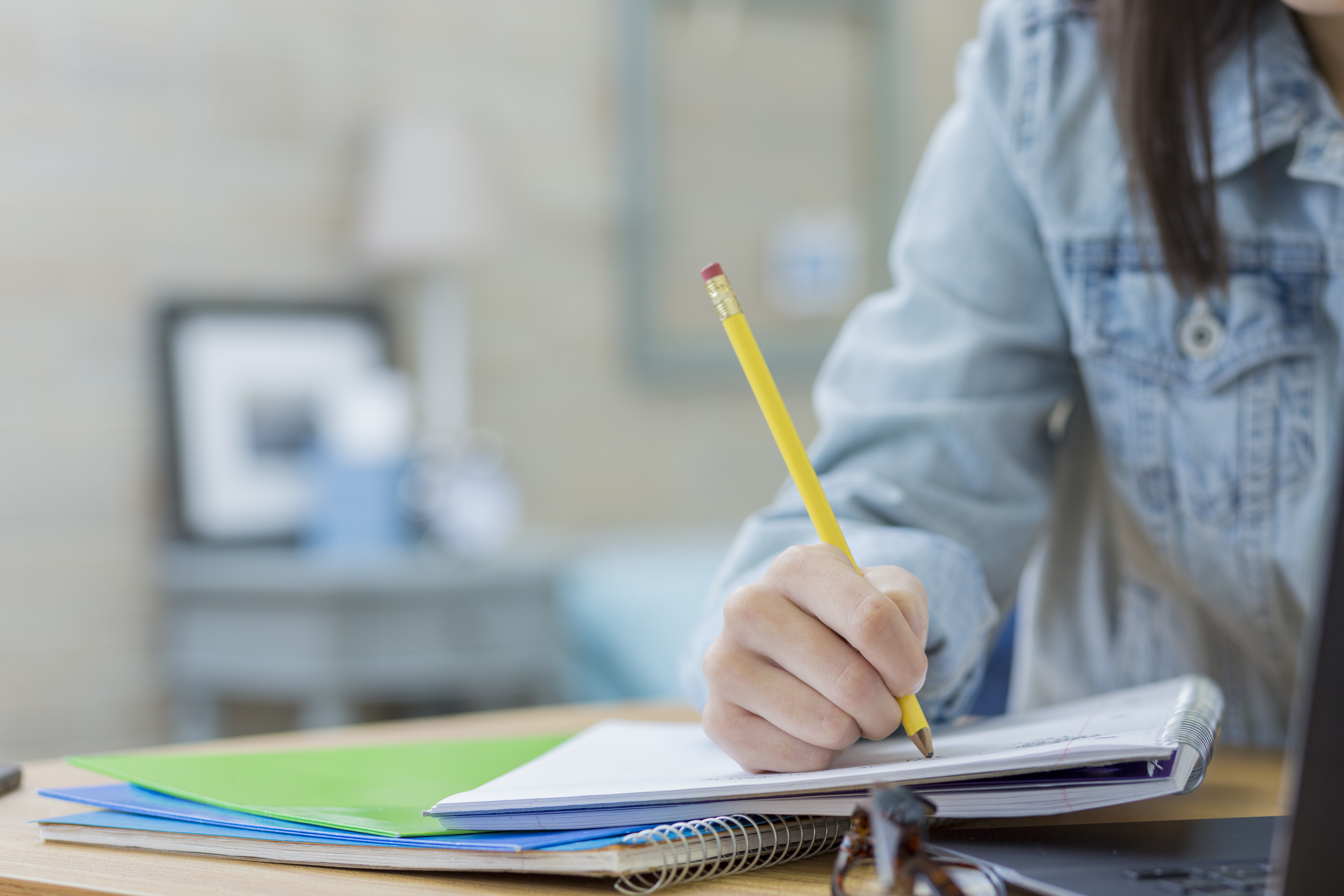 Woman with pencil and notepad writing