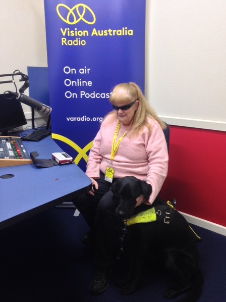 Vision Australia Radio Adelaide volunteer Vicki in the studio with her guide dog Bella