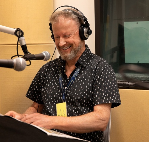 A picture of Chris Thompson presenting 'Behind the Scenes'