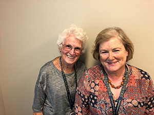 Two Perth volunteers happily smiling at the camera