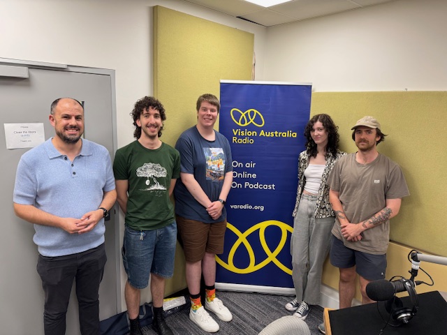 Pictured in front of a Vision Australia Radio banner in studio at Kooyong.   L – R: Swinburne Media and Communications lecturer Peter Mercato with students Louis, Nathan, Sarah and Matthew