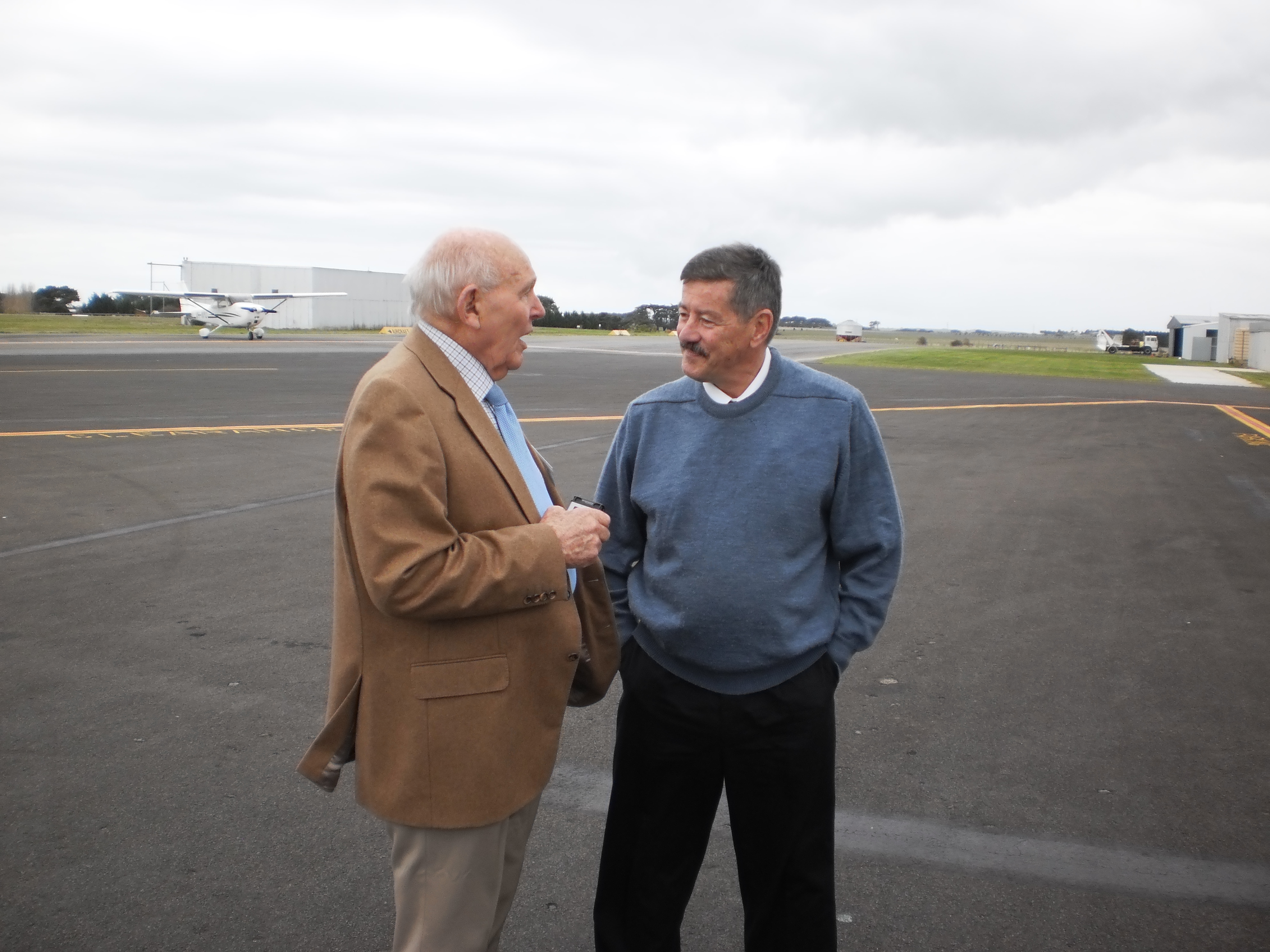 Graeme Bennet talks with Bob Small on a runway.