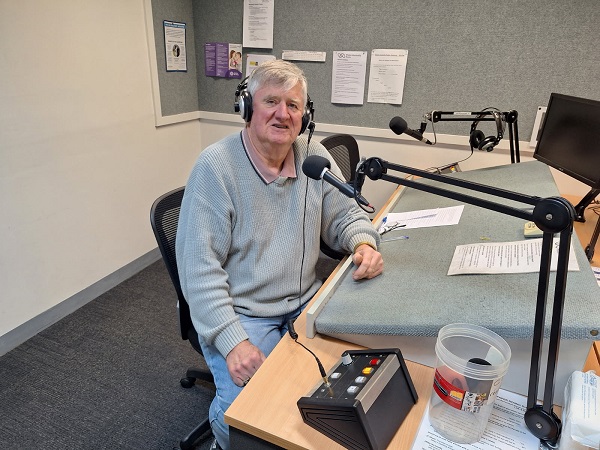 Vision Australia Radio volunteer Peter sits in the studio in Geelong.